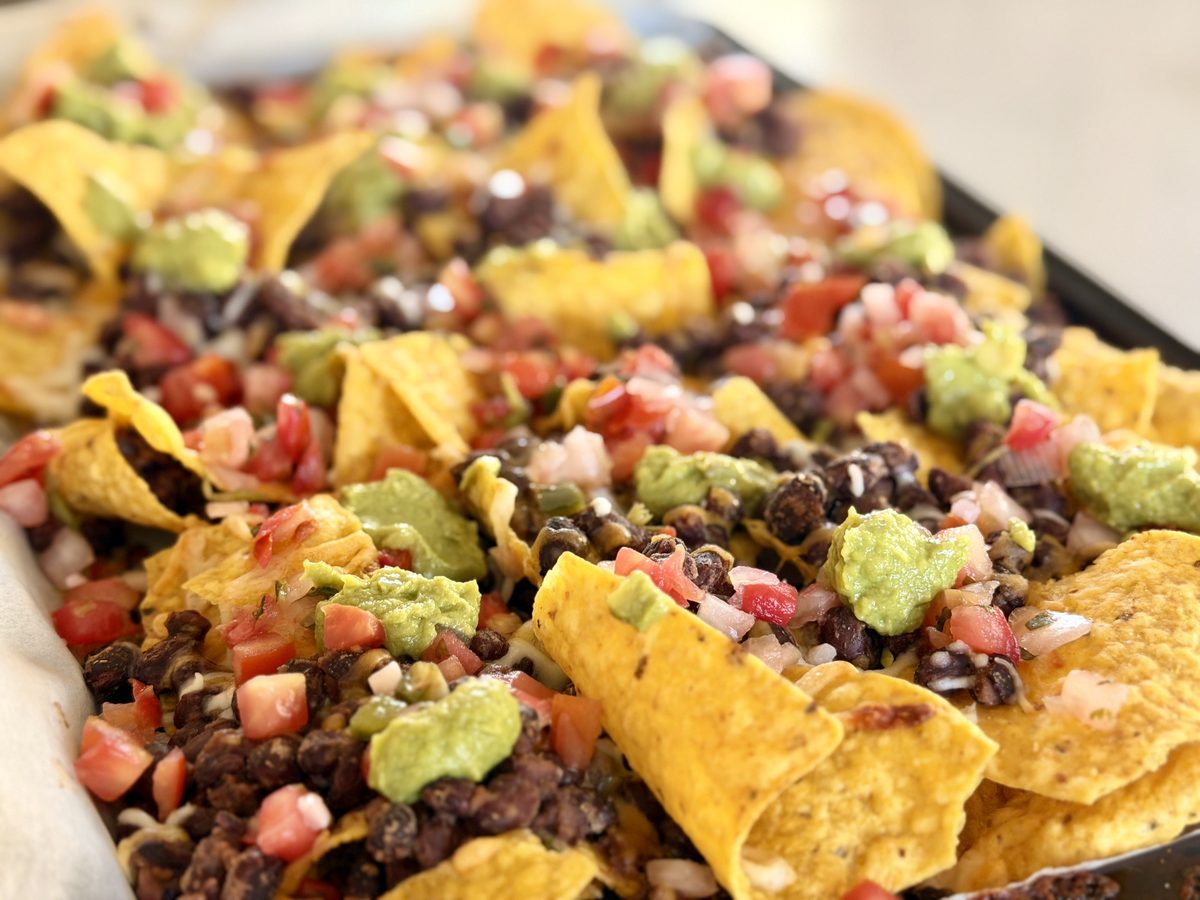 tray of black bean nachos with guacamole and pico